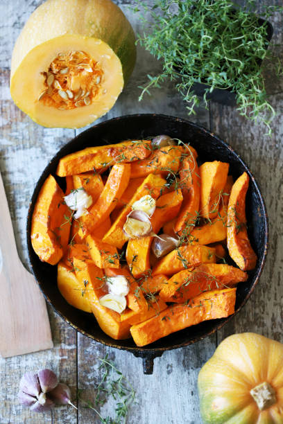 istock Sliced pumpkin in a pan with thyme and garlic. 1284749609
