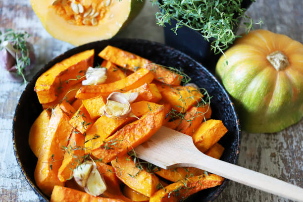 istock Baked pumpkin slices in a pan with herbs and garlic. 1284749629