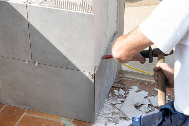 istock the mason prepares the wall with a chisel before laying a ceramic tile 1284750866