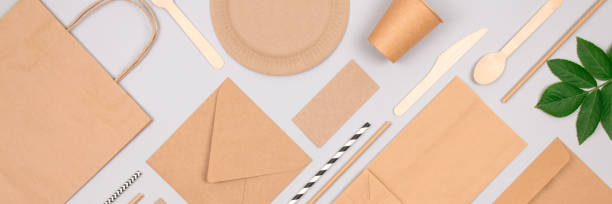 istock Banner with flat lay composition with eco-friendly tableware - set of kraft paper packaging on light grey background. Street food packaging, recyclable paperware, zero waste packaging concept. Mockup 1284750868