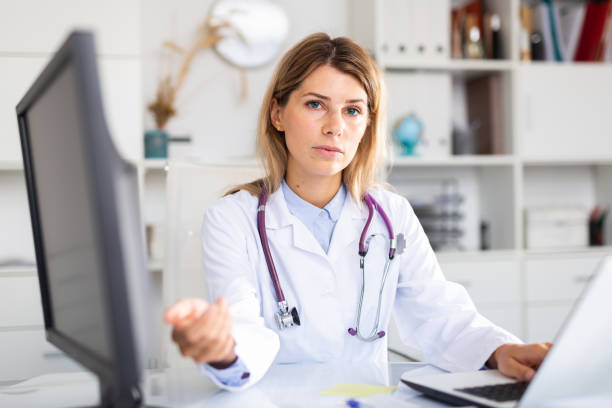 istock Female doctor making welcome gesture, politely inviting patient in office 1284751225