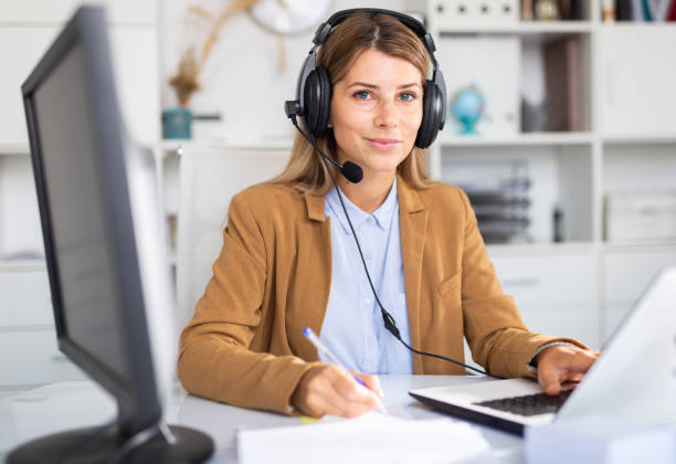 istock happy adult female operator working in white office 1284751240