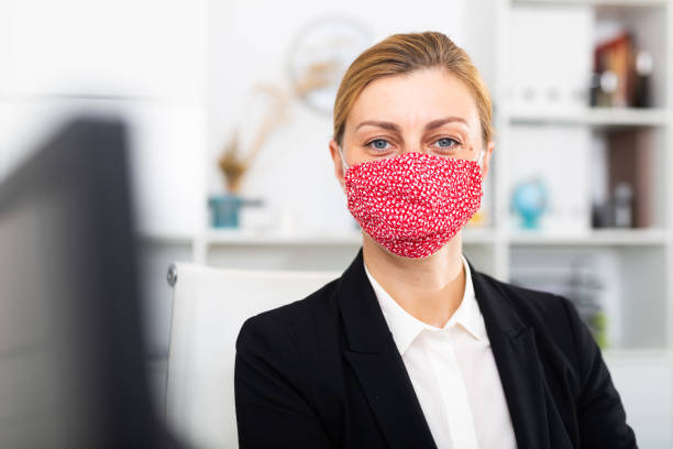 istock Woman manager in medical mask in office while working day 1284752219