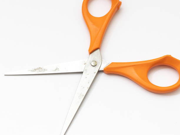 istock Orange scissor with white background. 1284752311