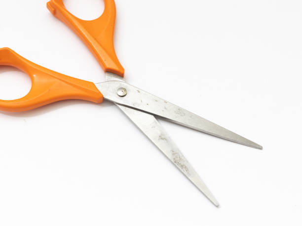 istock Orange scissor with white background. 1284752331