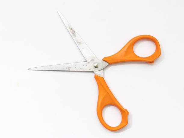 istock Orange scissor with white background. 1284752339