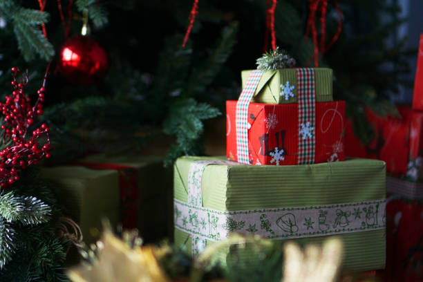 istock Beautiful Christmas green and red gift boxes under the Christmas tree 1284752627