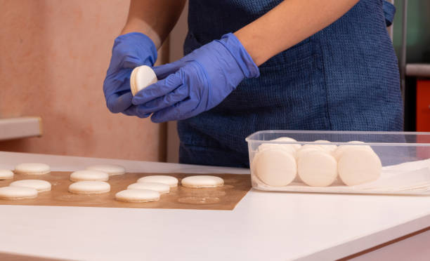 istock A girl in blue gloves collects macaroons. 1284752806