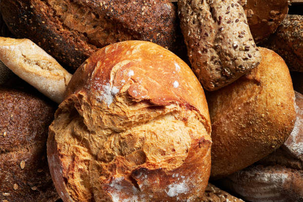 istock Different Types of Bread put in a wooden box on dark background. Bakery concept. Close up. 1284753904