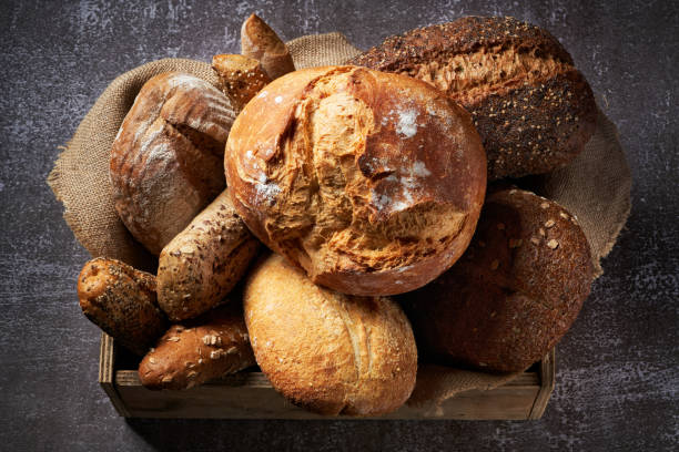 istock Different Types of Bread put in a wooden box on dark background. Bakery concept. Close up. 1284753905