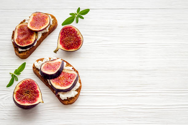 istock Toasted bread with figs, cheese and honey on table 1284754252
