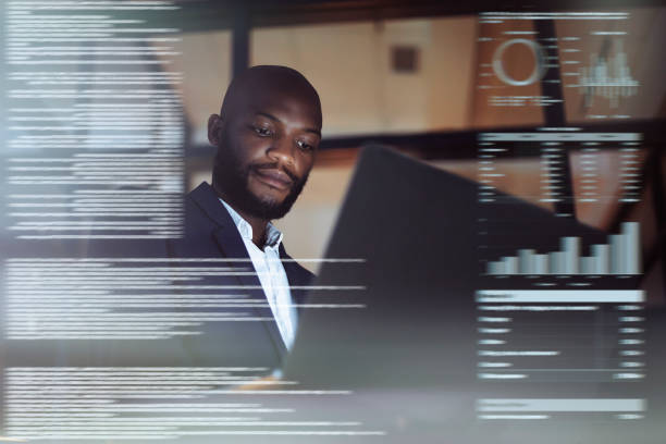 istock Shot of a young man using a laptop while working late in their office 1284754281