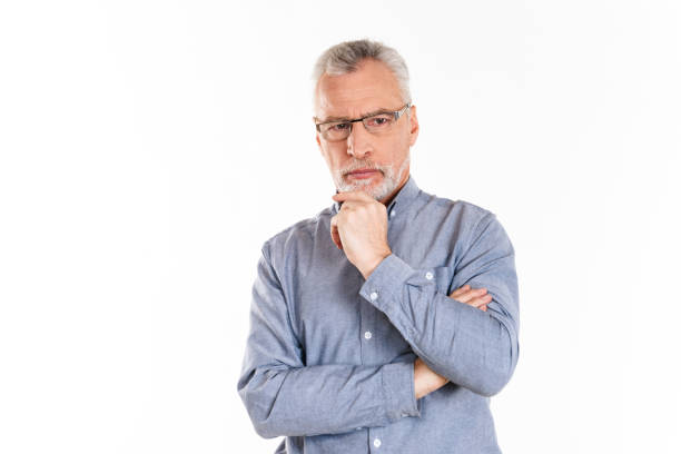 istock Portrait of serious confident man looking aside with folded hands 1284754342