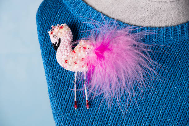 Pink Flamingo brooch with beads on a blue knitted jacket