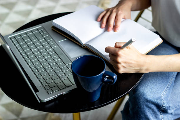 istock Woman working at home office - writing in notebook 1284755484