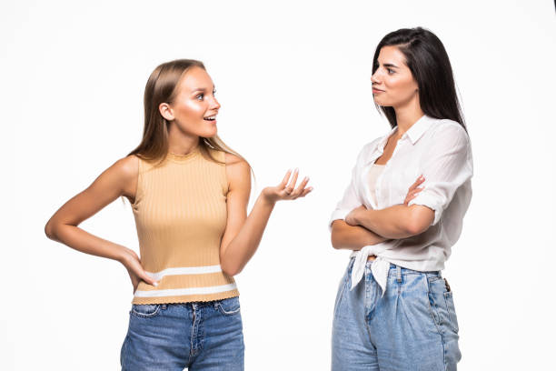 istock Two young females having a conversation, isolated on white background 1284755888