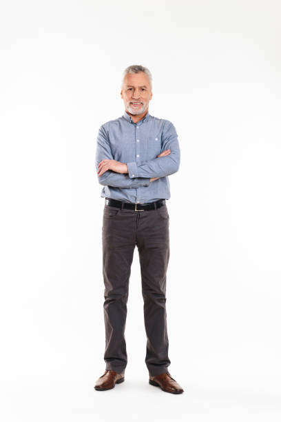 istock Old grey-haired man with folded hands and smiling to camera isolated 1284757149