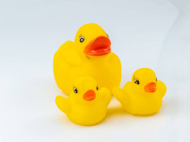 istock Yellow Rubber Ducks Mom and Childs Figures on White Background 1284757540