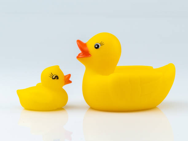 istock Yellow Rubber Ducks Mom and Childs Figures on White Background 1284757554