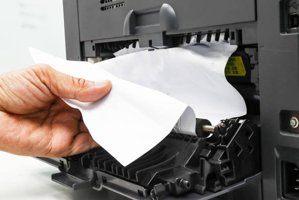 istock Technicians Removing Paper Stuck, Paper Jam In Printer At Office 1284758990
