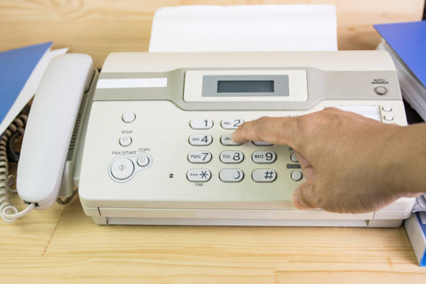 istock hand man are using a fax machine in the office, equipment for data transmission. 1284759234