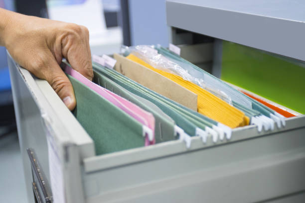 Hand of Man Search files document in a file cabinet in work office, concept business office life. stock photo