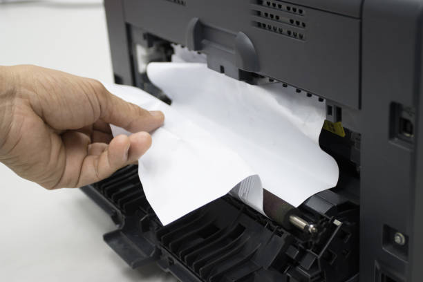 istock Technicians Removing Paper Stuck, Paper Jam In Printer At Office 1284759327