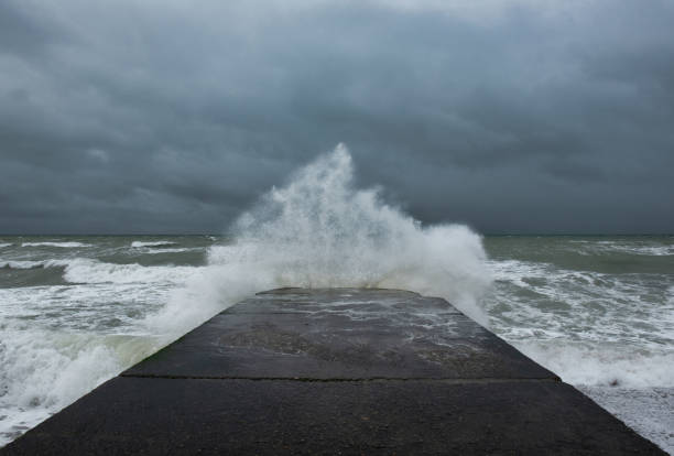 istock Wave splash against a concrete groyne during yellow weather warning in Brighton, England 1284759485