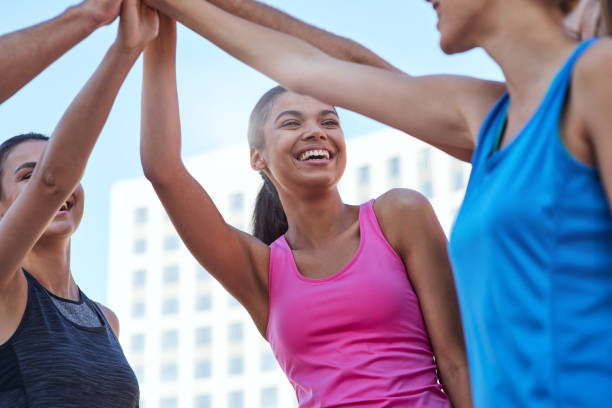 istock Happy young sport team holding raised hands together 1284759591