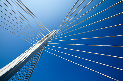 Wonderful white bridge structure over clear blue sky. Abstract detail