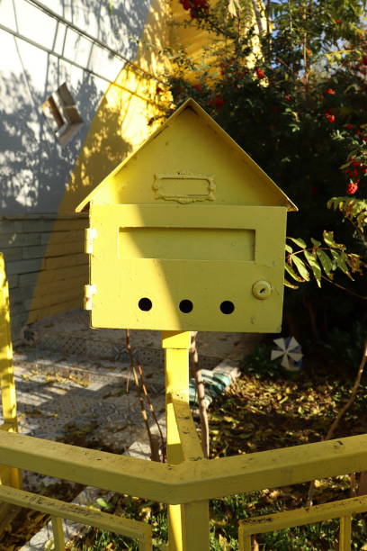 istock nostalgic mailbox made of iron material, painted yellow, in the garden. 1284760600