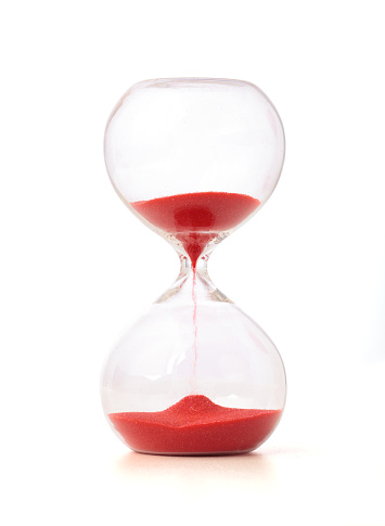 Hourglass with red sand on white background. includes a clipping path