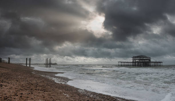 Brighton's stoney beach and West Pier ruins, England