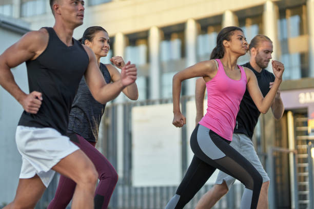 istock Young multiracial runners competing on city street 1284761895