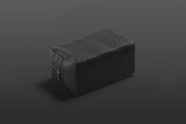 istock Blank black canvas cosmetic bag mockup lying, dark background 1284762420