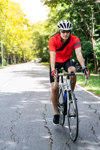 istock Asian man cycle in countryside road 1284762593