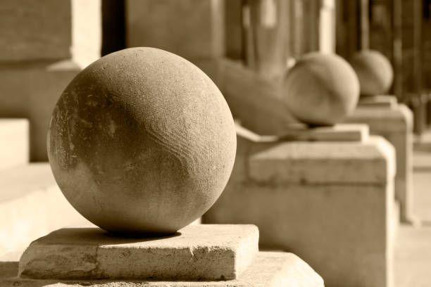 istock Stone balls on pedestals in a row 1284762643