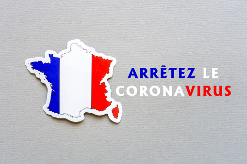 Stop coronavirus in France. Map of France with french flag on gray paper background. Text in French STOP CORONAVIRUS. Covid-19 outbreak, pandemic concept.