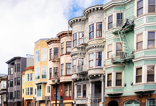 A street of old-fashioned terraced apartment buildings and townhouses in San Francisco, California.