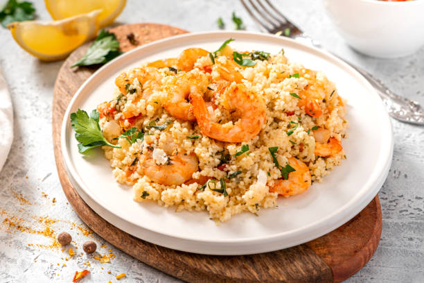 istock Couscous with shrimps, tomatoes, onions, and herbs 1284764923