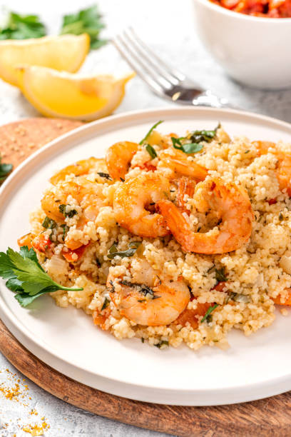 istock Couscous with shrimps, tomatoes, onions, and herbs 1284765151