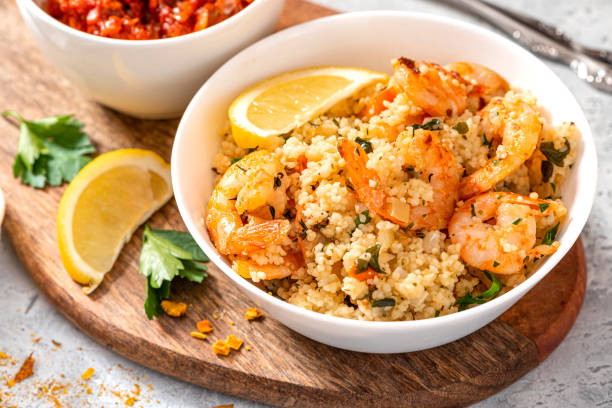 istock Couscous with shrimps, tomatoes, onions, and herbs 1284765153