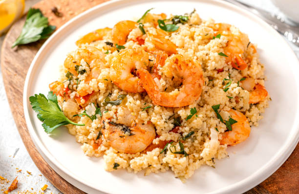 istock Couscous with shrimps, tomatoes, onions, and herbs 1284765154