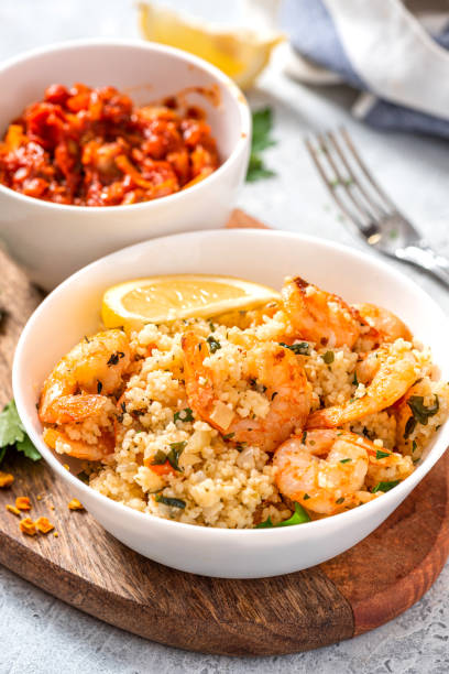 istock Couscous with shrimps, tomatoes, onions, and herbs 1284765368