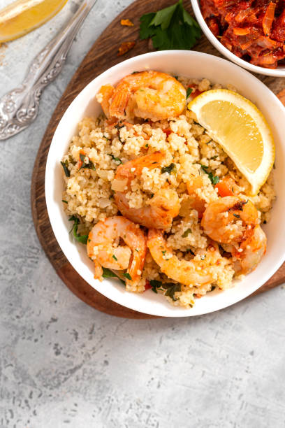 istock Couscous with fried shrimps, tomatoes, onions, and herbs 1284765389