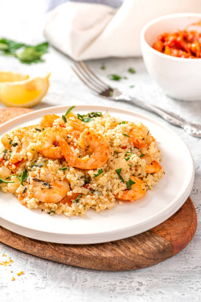 istock Couscous with shrimps, tomatoes, onions, and herbs 1284765397