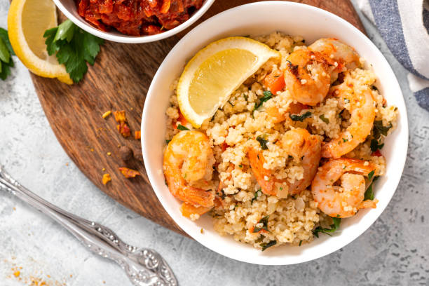 istock Couscous with fried shrimps, tomatoes, onions, and herbs 1284765427
