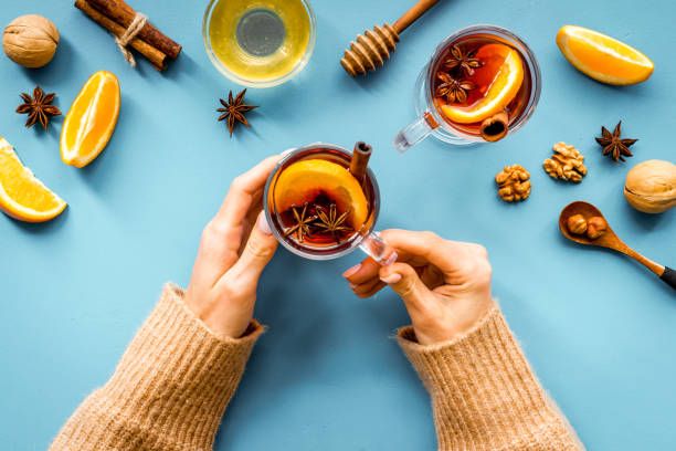 istock Female hands holding glass with mulled wine - Christmas hot drink 1284765730