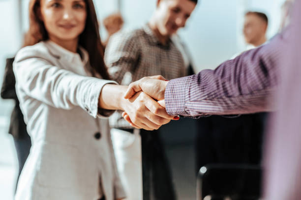 istock close up. young casual business people shaking hands with each 1284765757
