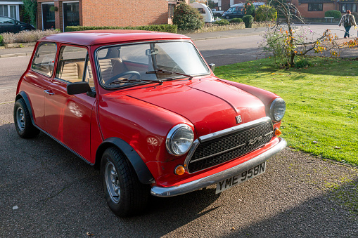 This is a 1974 Classic Mini Cooper Innocenti 1300 Export.  This is a front view of the whole car on the owners drive.